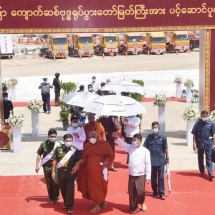 Conveyance ceremony of part-1 of Bhumi Phassa Mudra Sitting Buddha Image by Pyigyimon Yadana decorated float flanked by royal boat entourage launched